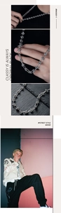 Macro detail of silver street style knot necklace with industrial chain link design