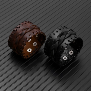 Detail of retro punk wide leather bracelets featuring hand-stitched edges and woven layers