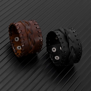 Detail of vintage braided leather bracelets with adjustable metal snap buttons