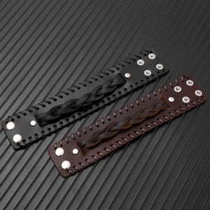 Detail of punk braided leather bracelets with silver studs in black and dark brown