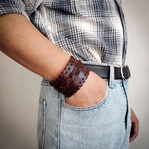 Close-up of deep brown multi-layer braided leather bracelet with vintage stitch detail