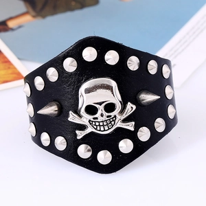 Punk style wide black leather bracelet featuring silver skull and sharp metal studs