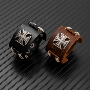 Detail of punk leather bracelets with metal cross and adjustable snap button closures