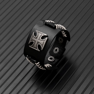 Detail of punk leather bracelet with iron cross and adjustable metal snap buttons