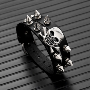 Macro detail of punk leather bracelet with metal skull and silver cone studs