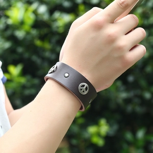 Men's punk brown leather bracelet featuring a silver metal peace sign and vintage studs