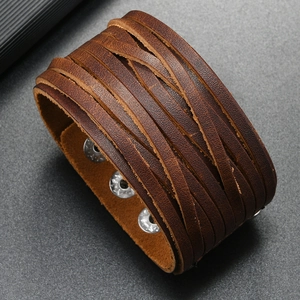Detail of brown multilayer leather bracelet with silver snap buttons and punk style texture