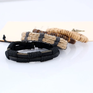 Detail of multi-layered braided leather, hemp rope, and wooden bead bracelets set