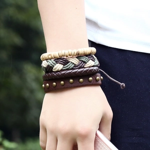 Set of four men's vintage woven leather bracelets with wooden beads and bronze rivets