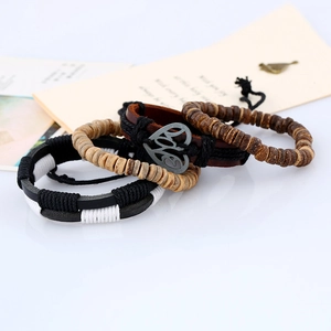 Detail of four-piece men bohemian bracelet set with leather and love charm