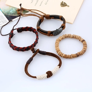 Set of four vintage braided leather and wood bead bracelets for men in retro style