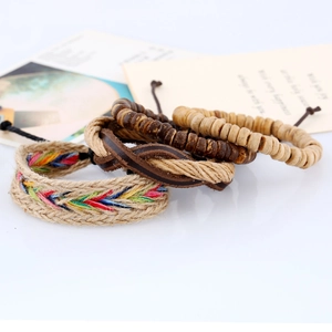 Detail of vintage bohemian handmade woven leather bracelet set with coconut shell beads