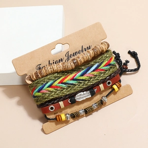 Detail of bohemian multilayer leather bracelets with wood beads and silver feather charm