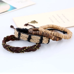 Detail of multi-layer vintage men's bracelets with brown braided leather and wooden beads