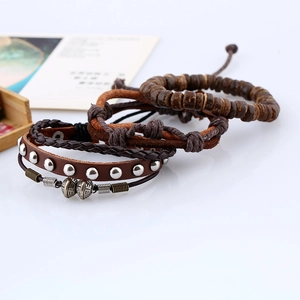 Detail view of multi-layer vintage leather bracelets with metal beads and wooden accents