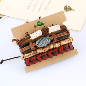 Close-up of four-piece men's vintage leather bracelet set with beads and metal shield