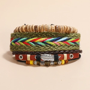 Detailed close-up of Bohemian multilayer leather bracelet set with silver feather charm