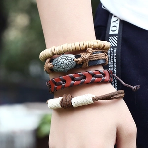 Close-up of men's vintage leather bracelet set featuring star charm and braided details