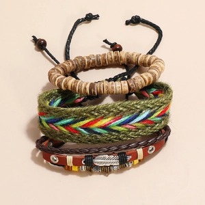Detail of multi-layer leather bracelets with wooden beads and a metal feather charm
