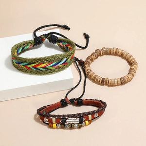 Detail view of bohemian multi-layer leather bracelets with wooden beads and feather pendant