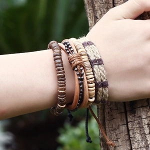 Men's multilayer leather bracelet set with wooden beads and bohemian woven ropes on wood