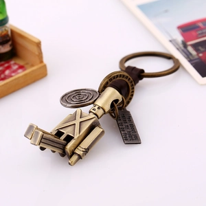 Vintage bronze robot keychain with movable limbs and hand-woven leather details