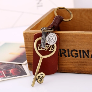 Vintage woven leather keychain with bronze LOVE key pendant and heart charm on wood box