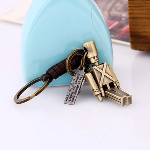 Handcrafted vintage bronze robot keychain with movable limbs and braided leather detail