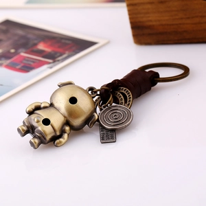 Porte-clés rétro en bronze avec lanière en cuir tressé et figurine vintage