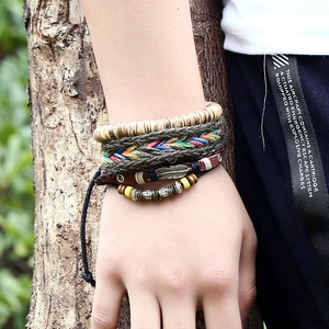 Bohemian multilayer leather bracelet set with wooden beads and bronze feather pendant