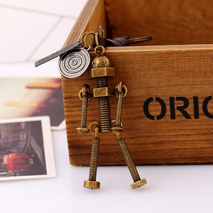 Vintage steampunk robot keychain in bronze finish with brown leather strap and metal tags