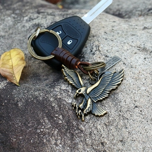 Vintage braided leather keychain with bronze eagle pendant and inspirational metal tag