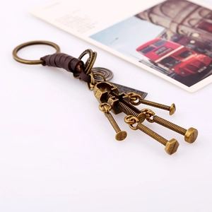 Vintage bronze robot keychain with leather wrap and I Love You tag on white surface