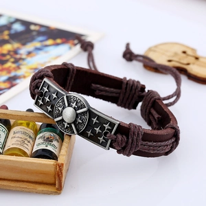 Vintage brown leather woven bracelet with antique silver compass metal plate in retro style