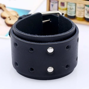 Macro detail of punk leather bracelet featuring double rows of silver rivets and metal buckle