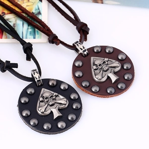 Detail of punk leather necklaces featuring retro silver skull pendants and rivets