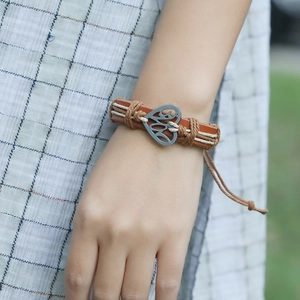 Vintage braided brown leather bracelet with silver heart charm and adjustable rope cord