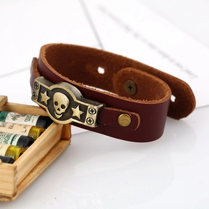 Retro brown genuine leather bracelet with bronze skull and stars on white background