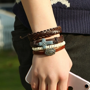 Four-piece handmade leather bracelet set with cross charm and beads on male wrist