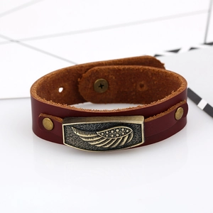 Vintage brown leather bracelet featuring detailed alloy wings and metallic bronze rivets