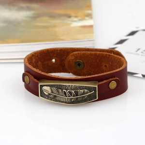 Retro brown leather bracelet with an antique bronze feather plaque and snap closure