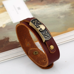 Punk style dark brown leather bracelet with vintage bronze skull charm and snap closure
