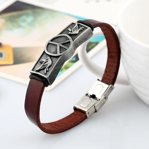 Vintage brown leather bracelet with silver peace sign and bird relief design