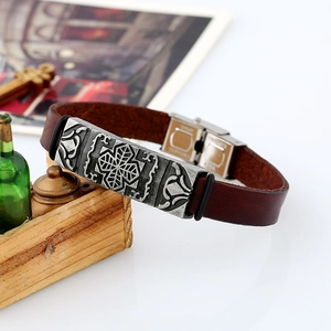 Vintage dark brown leather bracelet with an engraved silver cross plate and stainless steel buckle