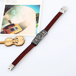 Vintage red-brown leather bracelet with an antique silver peace sign and dove metal charm