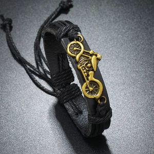 Detail of vintage bronze motorcycle charm on black braided leather bracelet for men