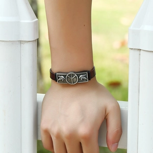 Retro leather bracelet for men featuring an antique silver peace sign and bird motifs