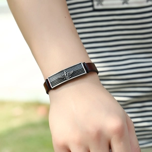 Men's vintage dark brown leather bracelet with Faravahar symbol engraved on silver metal charm