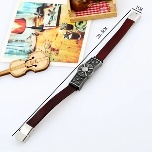 Vintage braided brown leather bracelet with star pattern metal charm and fold-over clasp