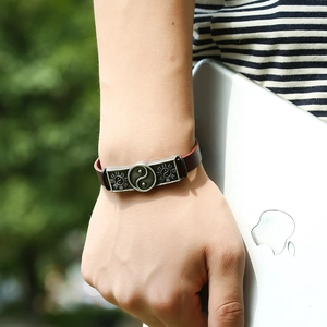Retro brown leather bracelet featuring a silver vintage yin yang and bagua metal charm